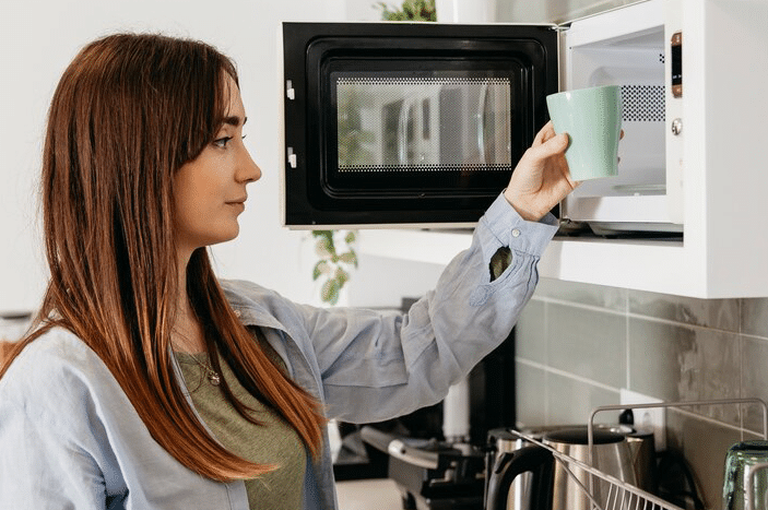 Is it safe to stand in front of a microwave while it's on? Here's what experts say.